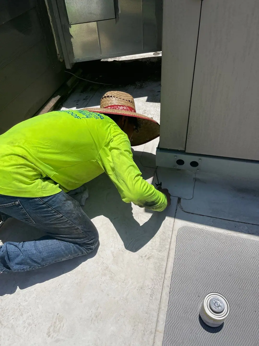 JC&C roofer repairing TPO flashing at the base of a wall and rooftop unit