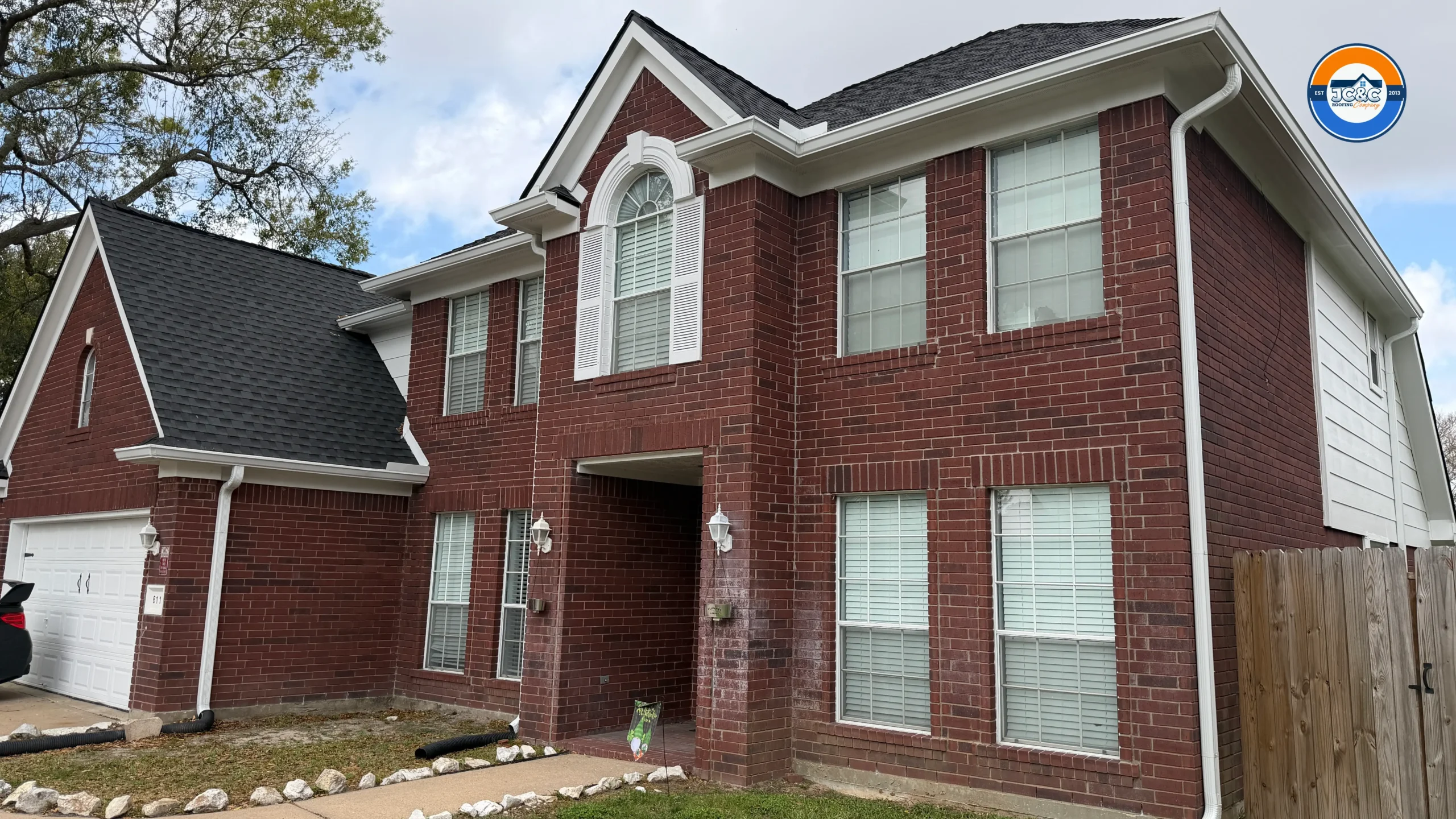 Same Houston home after professional home siding replacement and new roof installation by JC&C Roofing Company