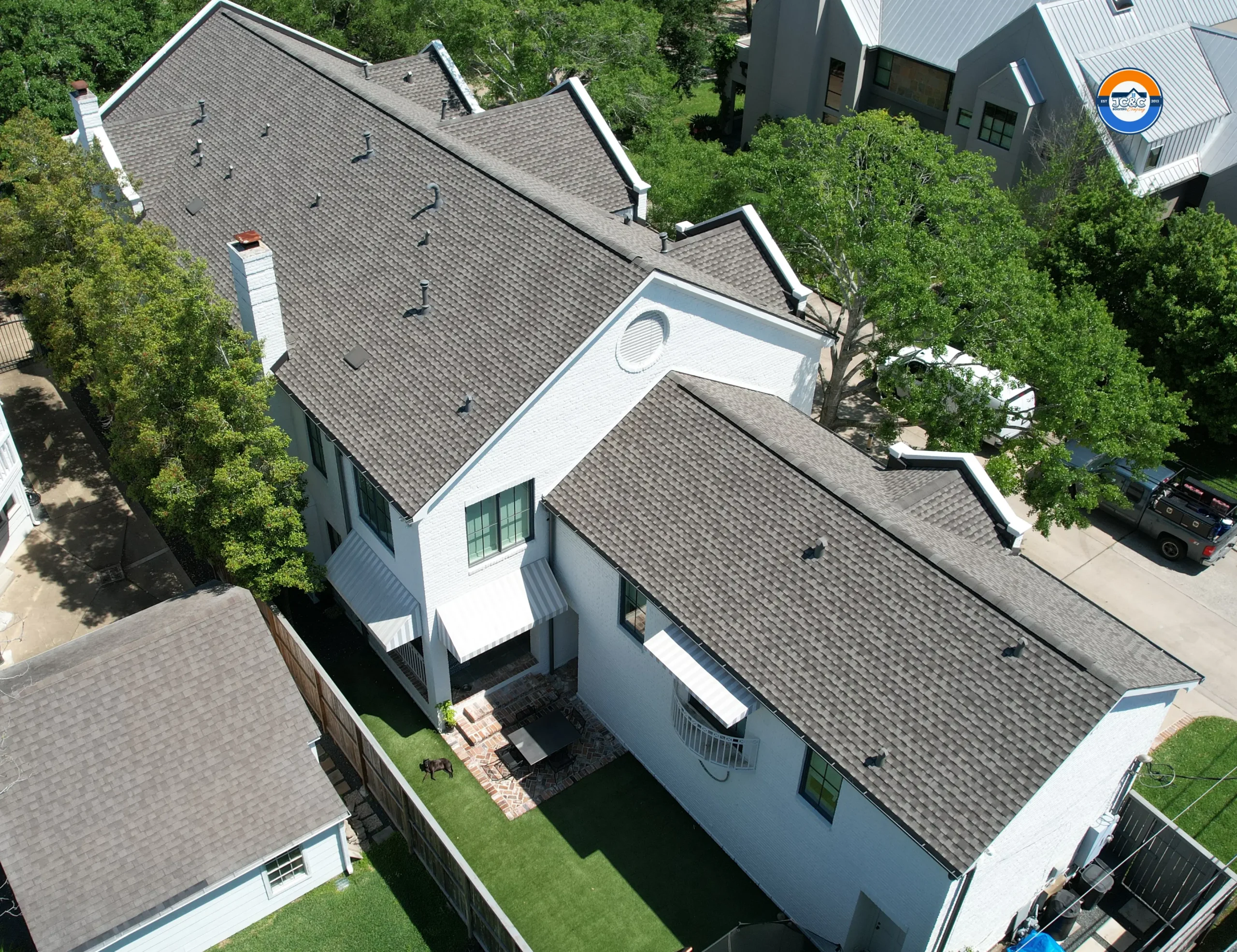 Roof replacement on a two-story home in West University Place, TX, by JC&C Roofing Company
